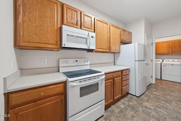 a kitchen with stainless steel appliances granite countertop a sink and a stove top oven