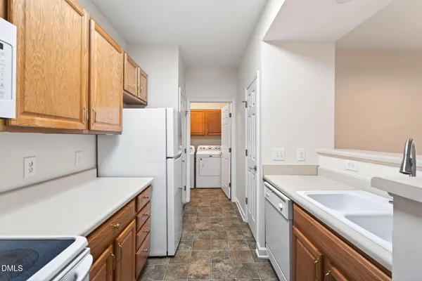 a kitchen with white cabinets and white appliances