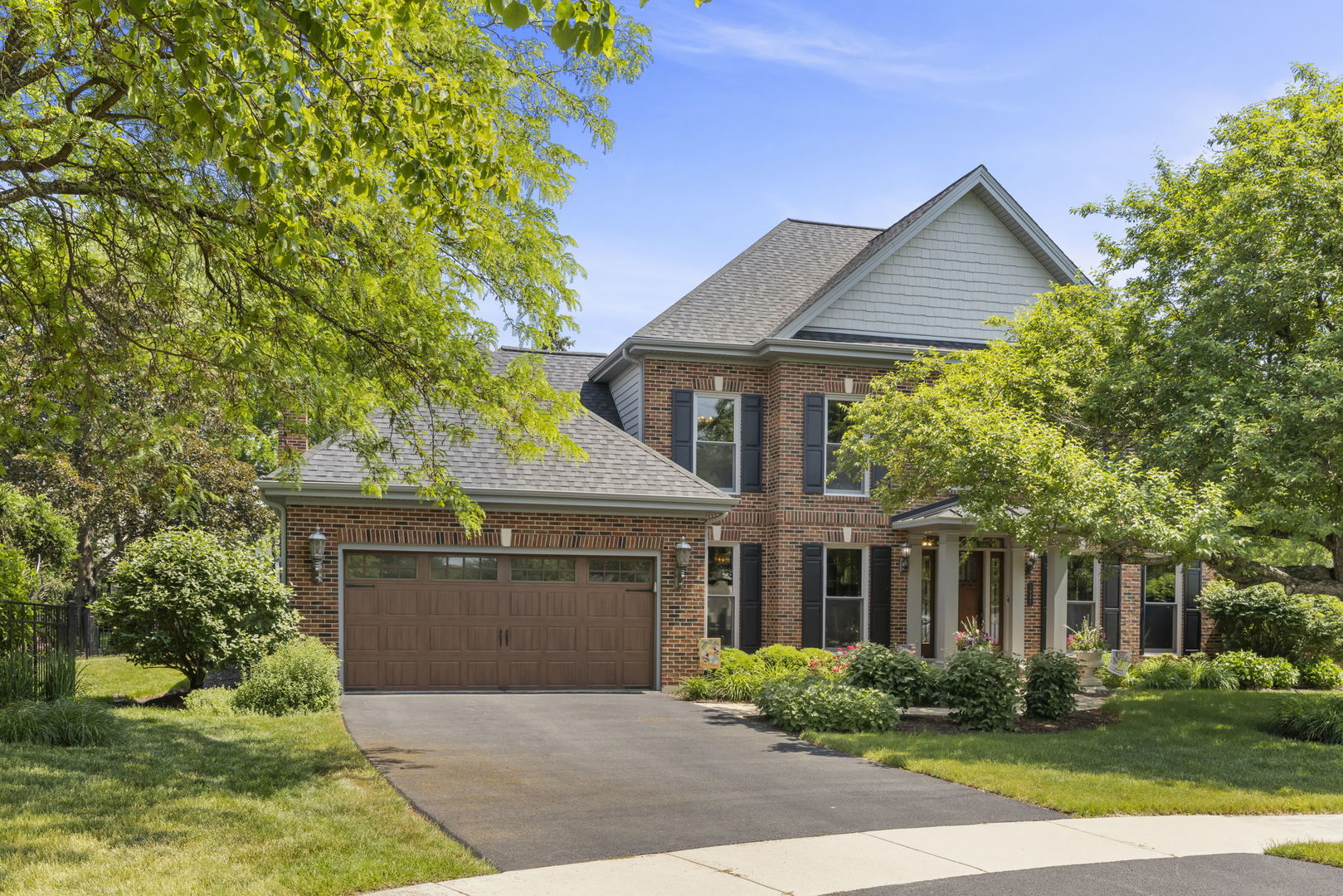 1921 Hampton Drive Wheaton, IL 60189 - Photo 1 of 54 a front view of a house with a garden