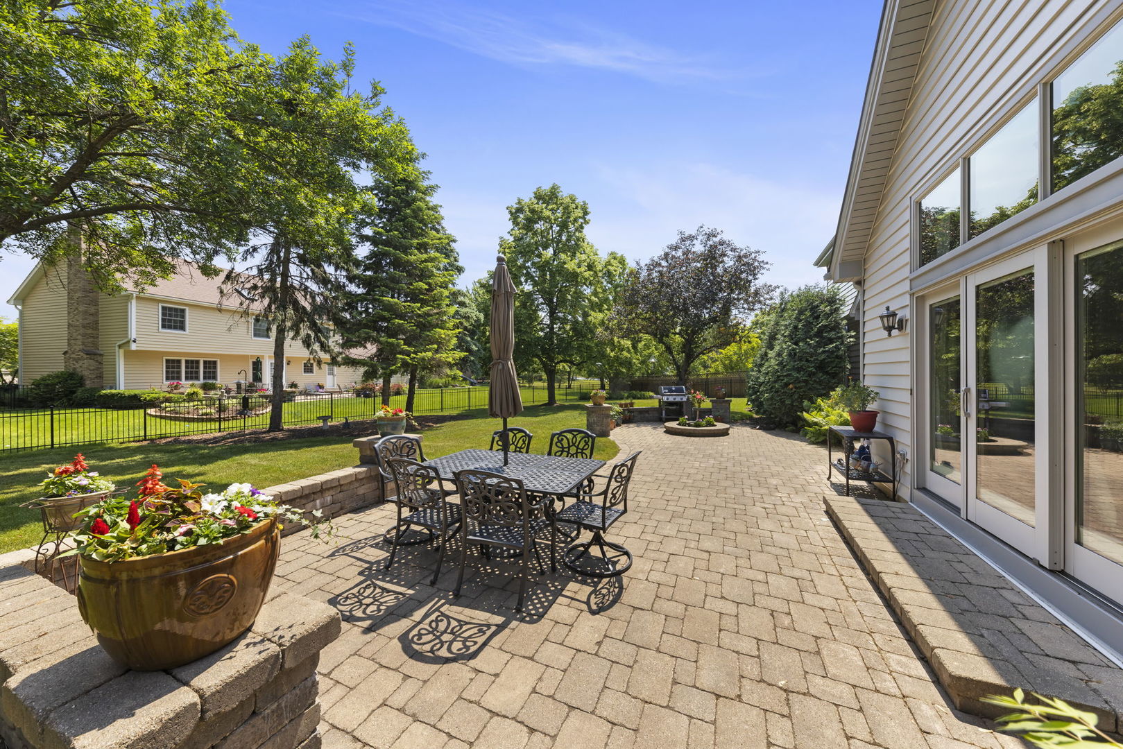1921 Hampton Drive Wheaton, IL 60189 - Photo 35 of 54 a view of a patio with table and chairs potted plants and large tree