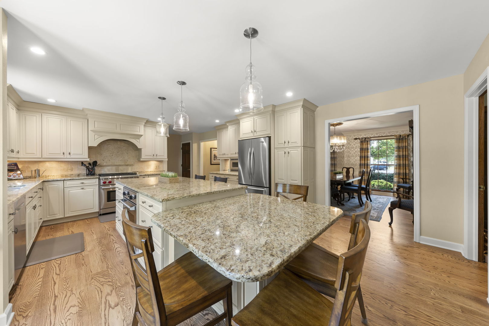 1921 Hampton Drive Wheaton, IL 60189 - Photo 4 of 54 a kitchen with stainless steel appliances granite countertop a stove refrigerator and cabinets