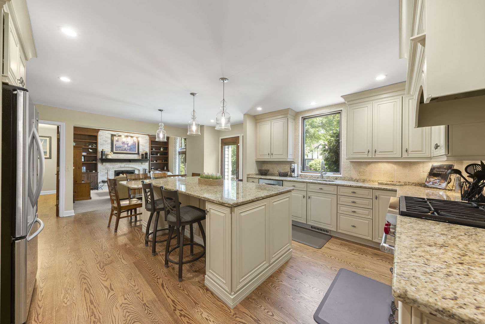1921 Hampton Drive Wheaton, IL 60189 - Photo 8 of 54 a kitchen with stainless steel appliances granite countertop a stove top oven a sink dishwasher a dining table and chairs with wooden floor