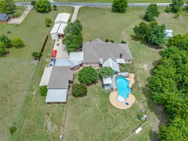 an aerial view of a house with outdoor space