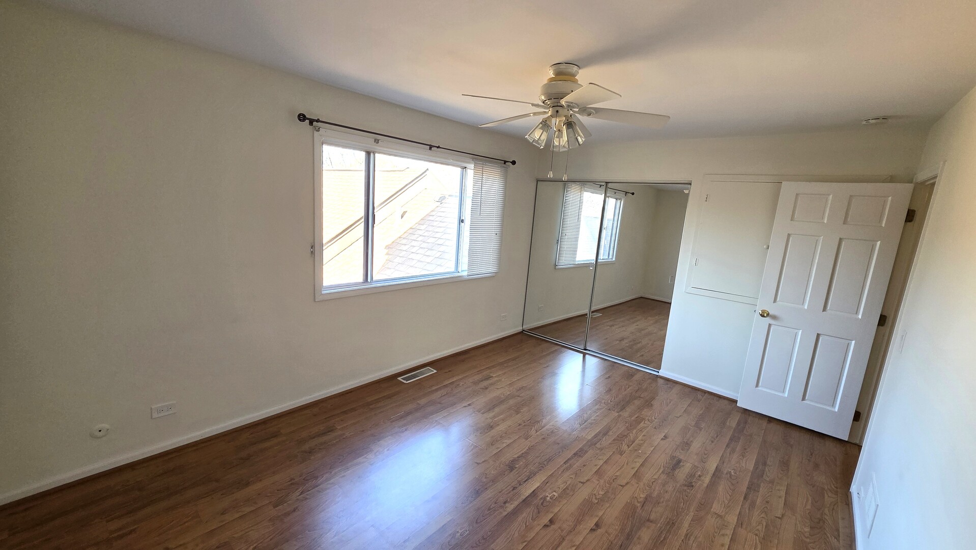 1117 Franklin Lane Buffalo Grove, IL 60089 - Photo 13 of 18 an empty room with wooden floor fan and windows