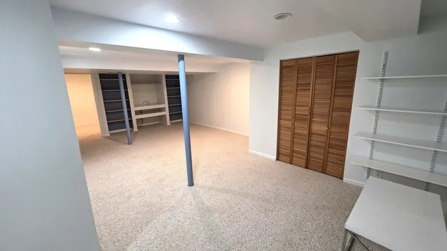 an empty room with a furniture and an empty room