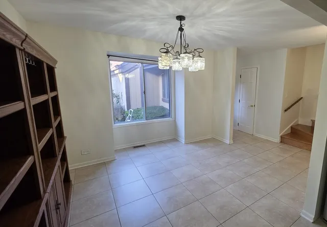 a view of a livingroom with a chandelier washer and dryer