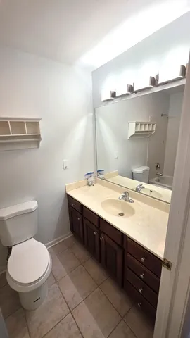 a bathroom with a sink a toilet and mirror