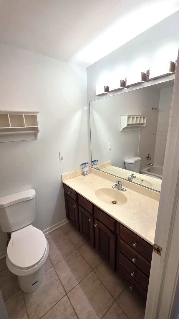 1117 Franklin Lane Buffalo Grove, IL 60089 - Photo 10 of 18 a bathroom with a sink a toilet and mirror