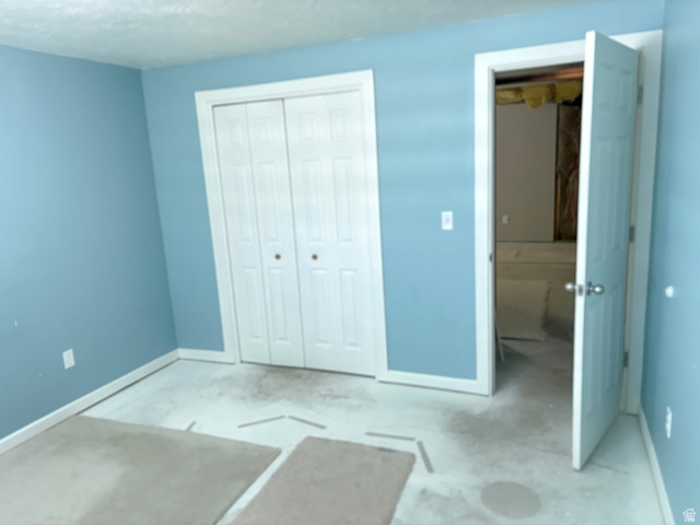 587 West 2400 South Perry, UT 84302 - Photo 42 of 46 Room featuring light blue walls, white trim, and a white bi-fold closet door