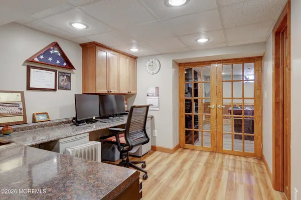a view of a workspace with furniture and a window