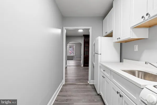 a kitchen with a refrigerator and a sink