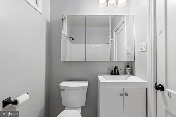 a bathroom with a sink toilet and vanity