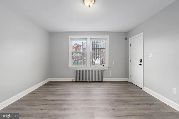 a view of an empty room with wooden floor