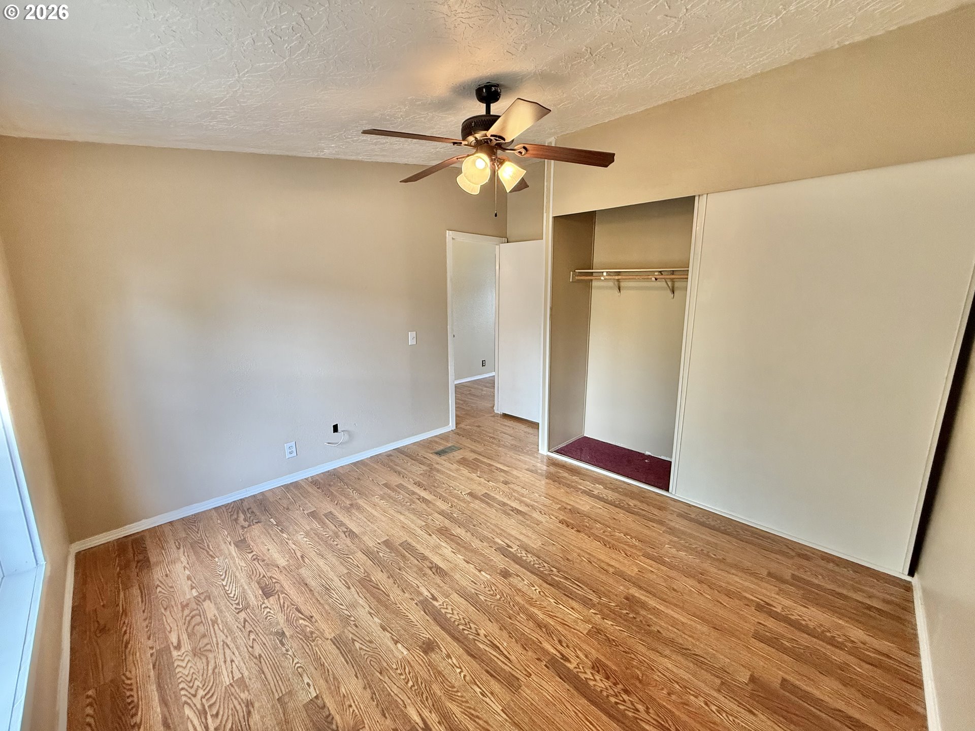 1282 3rd Street, Unit 37 Lafayette, OR 97127 - Photo 18 of 28 a view of an empty room with wooden floor and a window