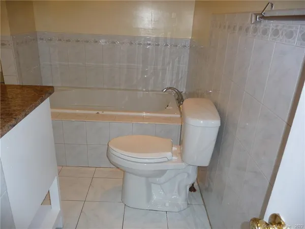 a bathroom with a toilet a sink and bathtub