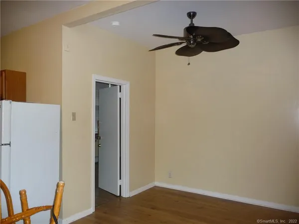 a view of a room with wooden floor and closet