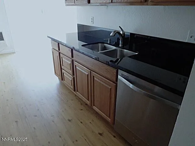 a kitchen with wooden cabinets and a sink