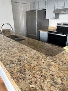 32 Peachtree Street Northwest, Unit 1506 Atlanta, GA 30303 - Photo 11 of 41 a kitchen with granite countertop a refrigerator and a stove