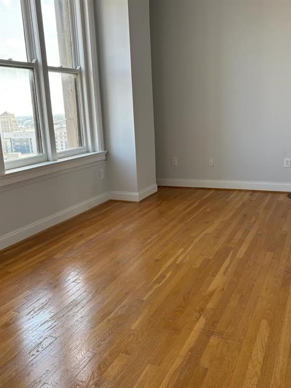 32 Peachtree Street Northwest, Unit 1506 Atlanta, GA 30303 - Photo 12 of 41 an empty room with wooden floor and windows