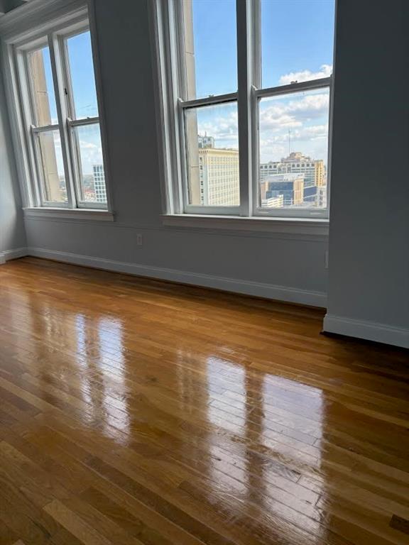 32 Peachtree Street Northwest, Unit 1506 Atlanta, GA 30303 - Photo 13 of 41 a view of an empty room with wooden floor and a window