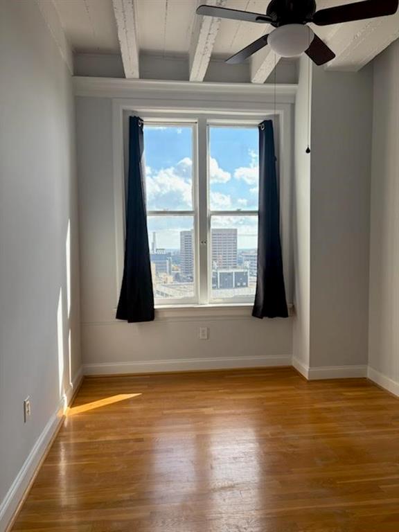 32 Peachtree Street Northwest, Unit 1506 Atlanta, GA 30303 - Photo 14 of 41 a view of an empty room with wooden floor and a window