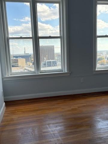 32 Peachtree Street Northwest, Unit 1506 Atlanta, GA 30303 - Photo 23 of 41 a view of an empty room with wooden floor and a window