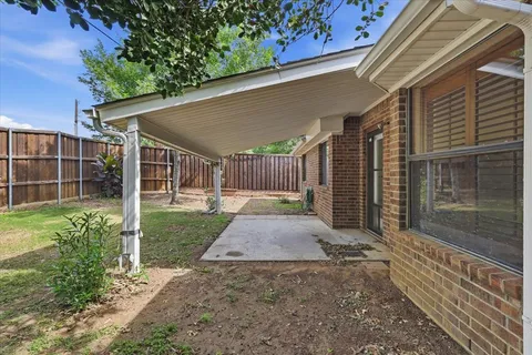 a backyard of house with a slide and large trees