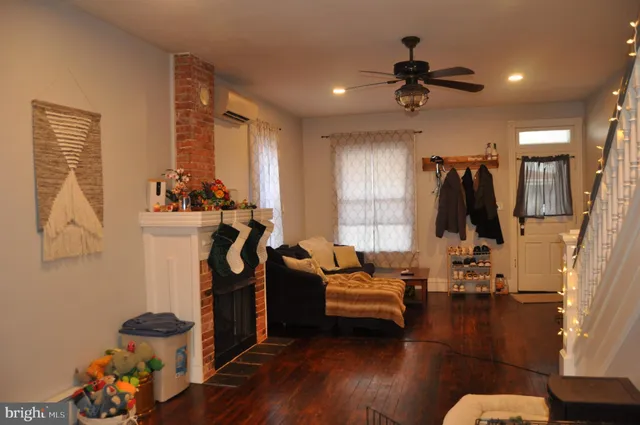 a view of a livingroom with furniture and hardwood floor