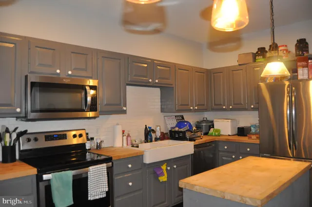 a kitchen with a sink stove and microwave