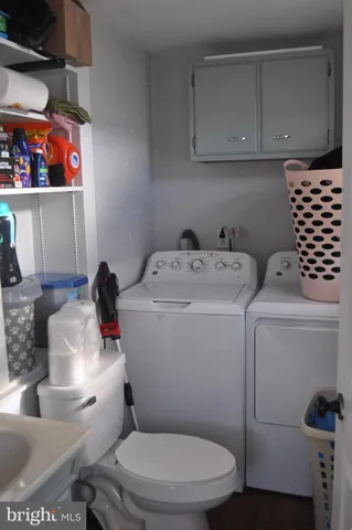 a bathroom with a toilet sink and cabinets