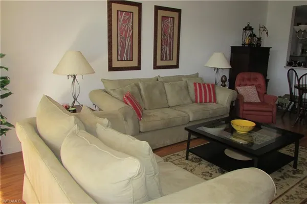 a living room with furniture and a lamp