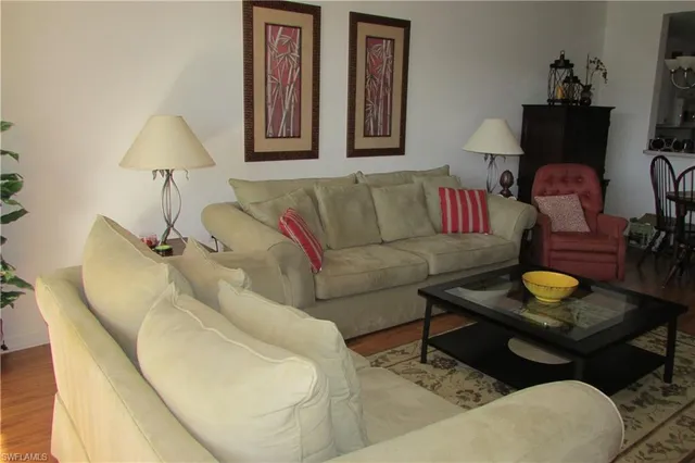 a living room with furniture and a lamp