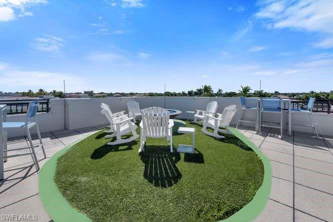 490 5th Street South, Unit 101 Naples, FL 34102 - Photo 25 of 34 a view of a swimming pool with sitting area