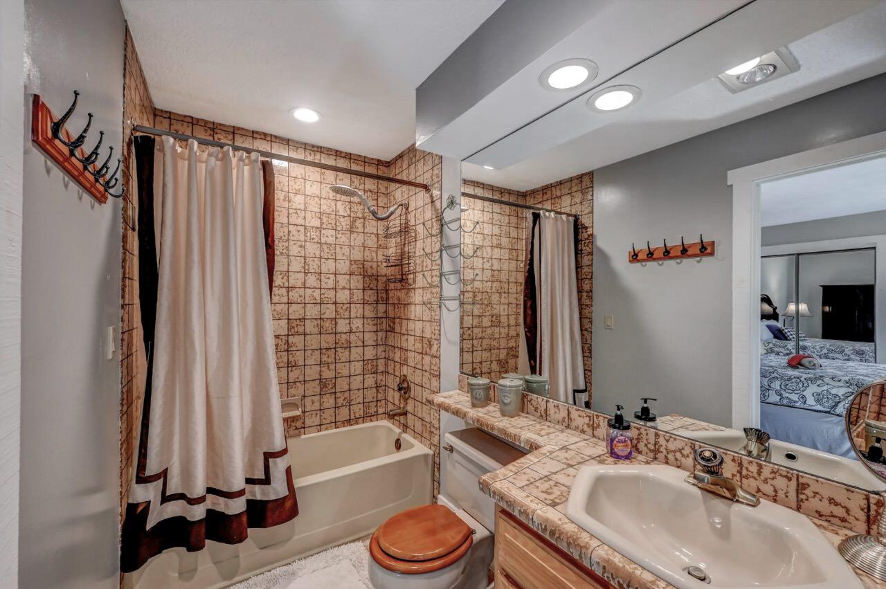 116 Snow Ridge Cir Lake Lake Harmony, PA 18624 - Photo 39 of 66 a bathroom with a granite countertop sink a toilet a large mirror and shower