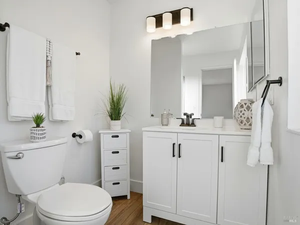 a bathroom with a white vanity a sink and a mirror