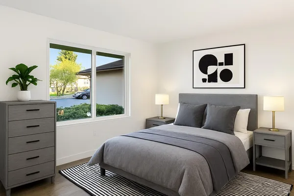 a bedroom with a bed and a window