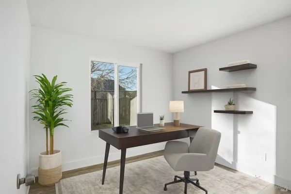 a workspace with furniture and a potted plant