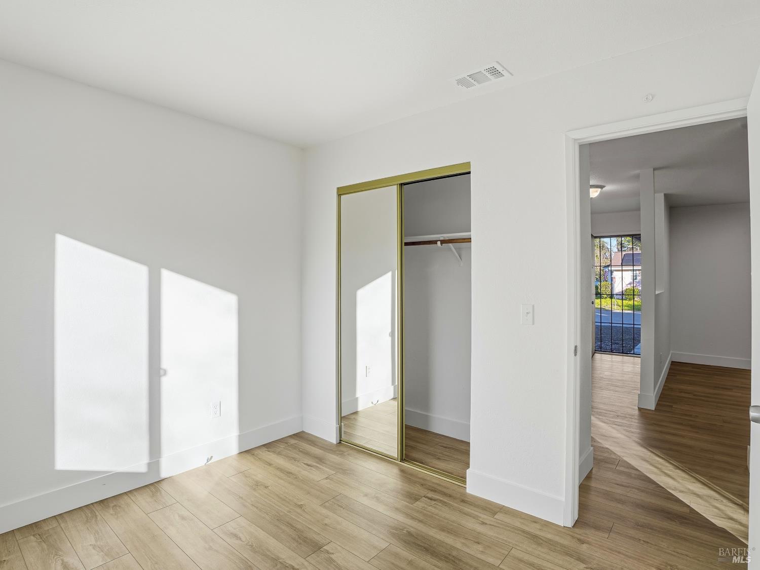 6041 Evelyn Avenue Rohnert Park, CA 94928 - Photo 30 of 37 an empty room with wooden floor and windows