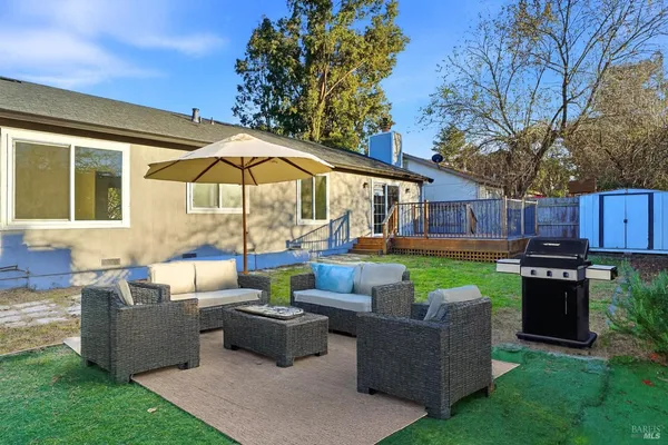 a view of a patio with couches chairs and a fire pit