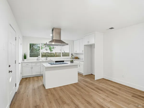 a kitchen with a stove a refrigerator and a stove top oven