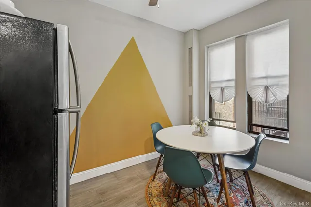 a view of a dining room with furniture and window