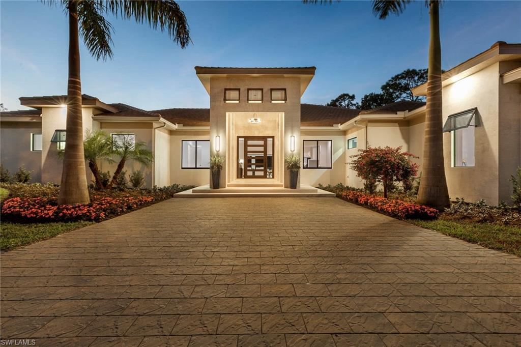 437 West Street Naples, FL 34108 - Photo 1 of 35 a front view of a house with a yard