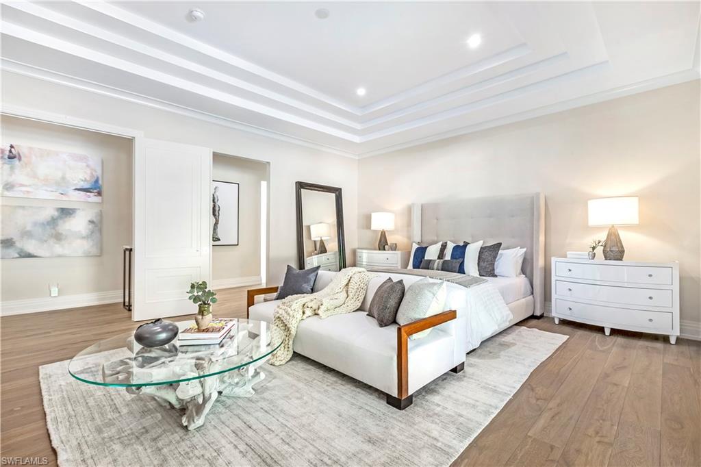 437 West Street Naples, FL 34108 - Photo 13 of 35 a spacious bedroom with a bed and wooden floor