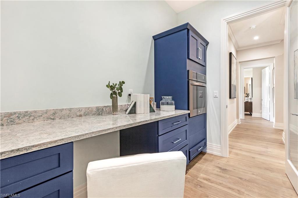 437 West Street Naples, FL 34108 - Photo 14 of 35 a spacious bathroom with a granite countertop sink a mirror and a bathtub