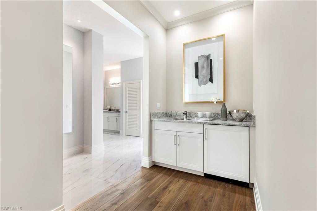 437 West Street Naples, FL 34108 - Photo 15 of 35 a bathroom with granite countertop a sink and a mirror
