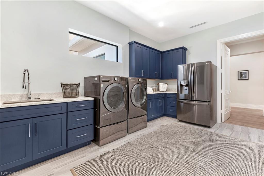 437 West Street Naples, FL 34108 - Photo 17 of 35 a kitchen with stainless steel appliances granite countertop a refrigerator sink and stove