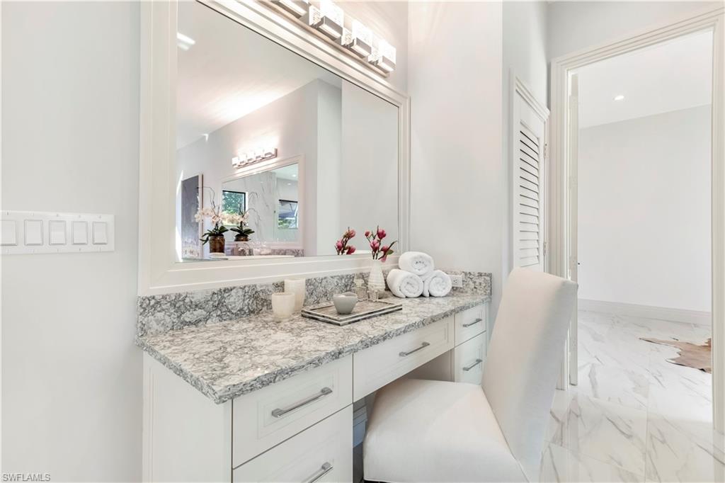 437 West Street Naples, FL 34108 - Photo 19 of 35 a bathroom with a granite countertop sink and a mirror