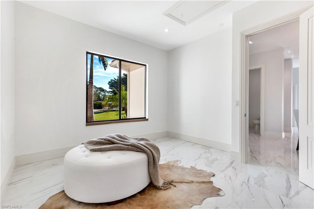 437 West Street Naples, FL 34108 - Photo 20 of 35 a bedroom with a bed and painting on the wall