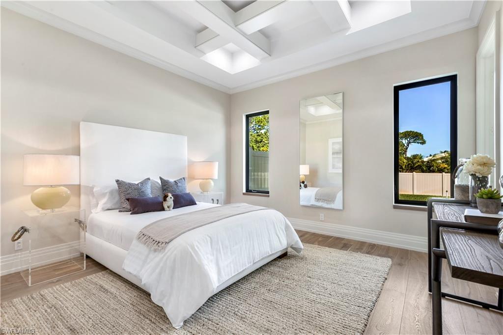 437 West Street Naples, FL 34108 - Photo 23 of 35 a bedroom with a large bed couch and a window