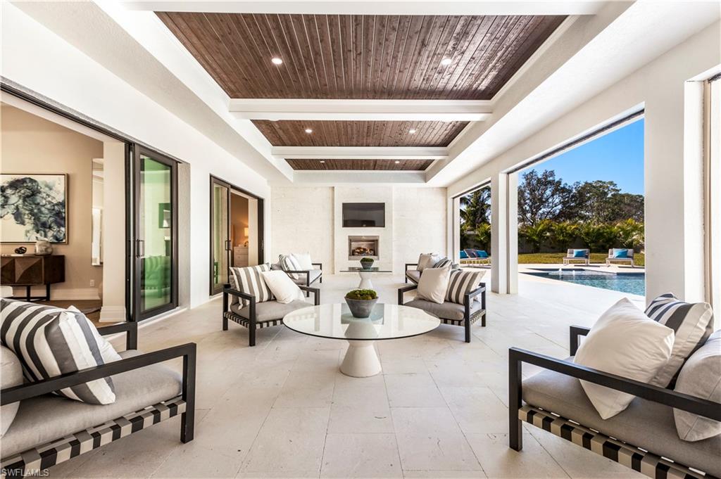 437 West Street Naples, FL 34108 - Photo 27 of 35 a living room with furniture and a flat screen tv